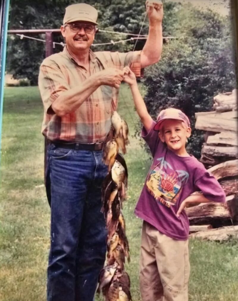 A young Tommy with his grandpa holding a string of fish, the moment that inspired TechMaid